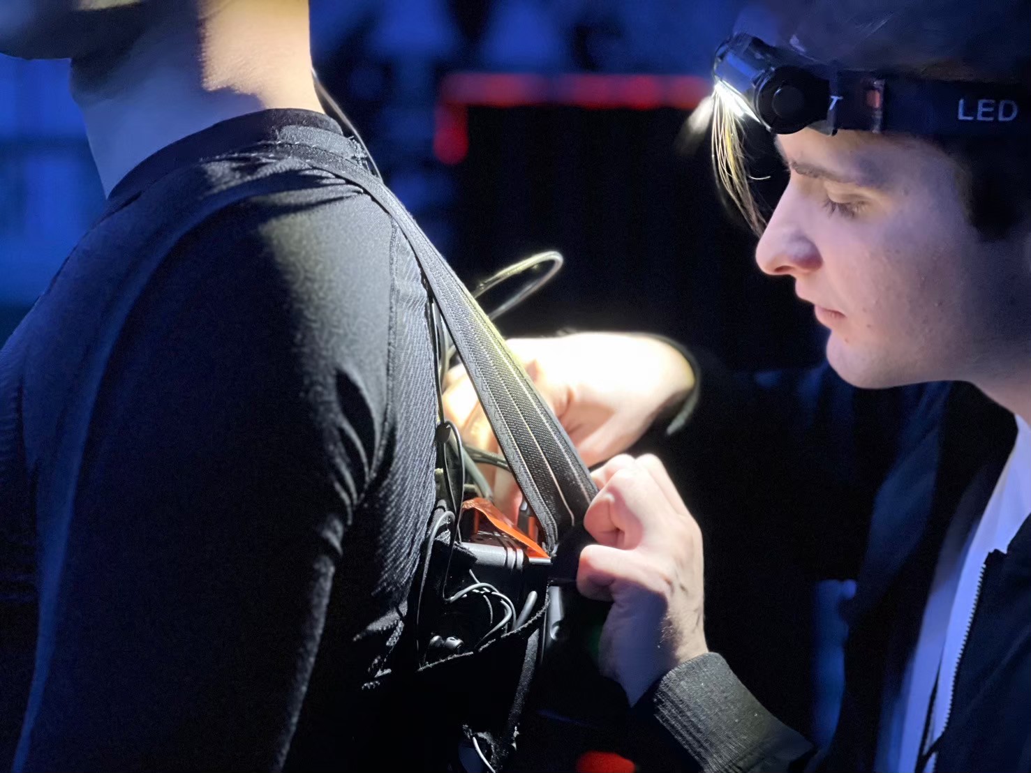 Equipping VR backpack on performer