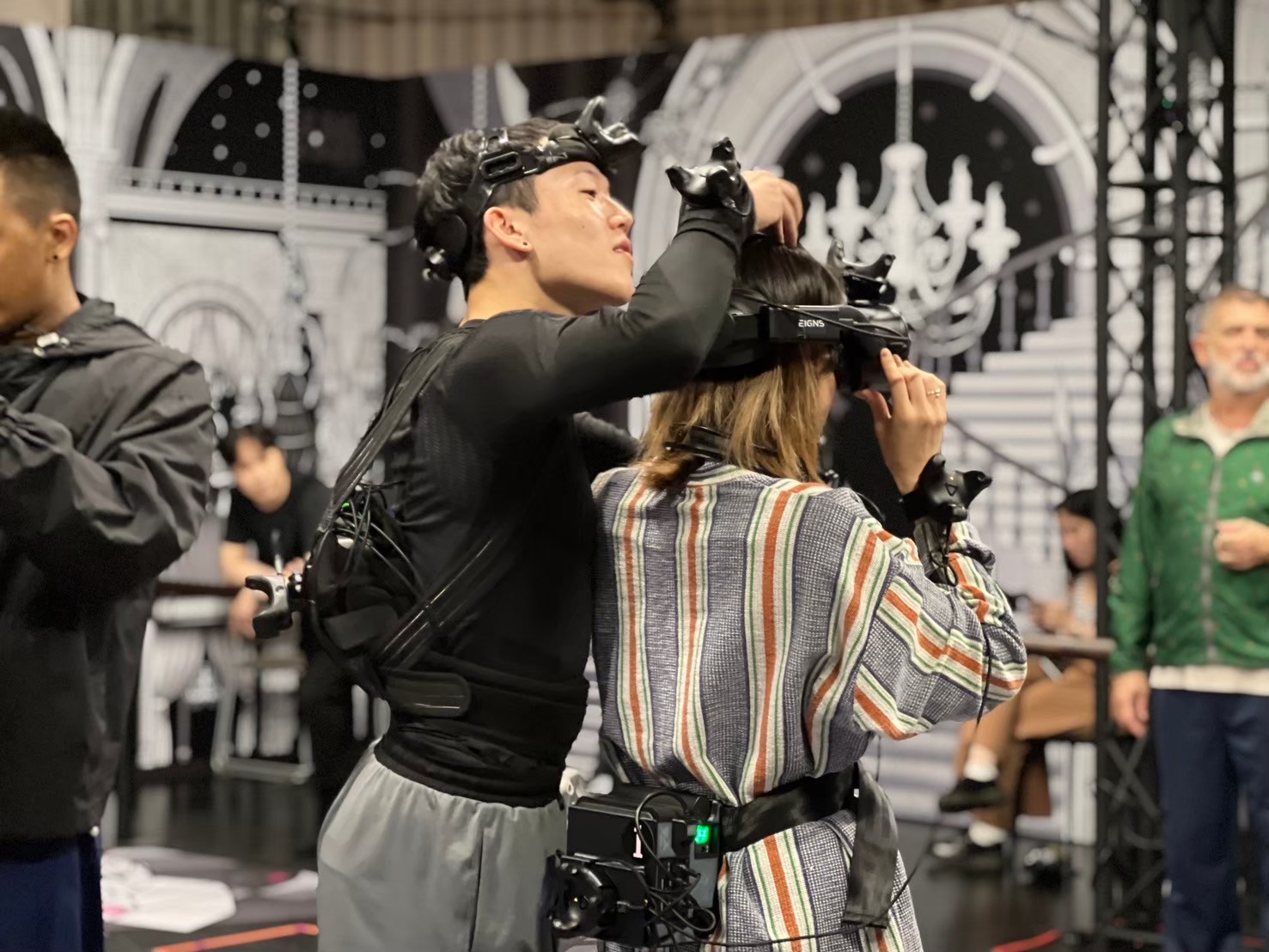 Staff assisting audience with VR gear