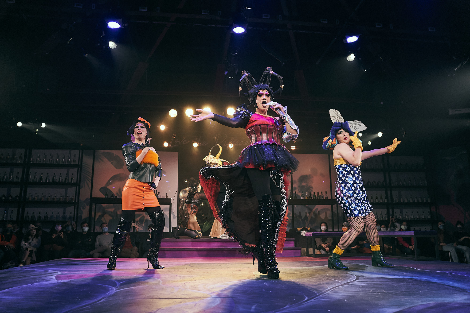 Trio of drag performers in pink light