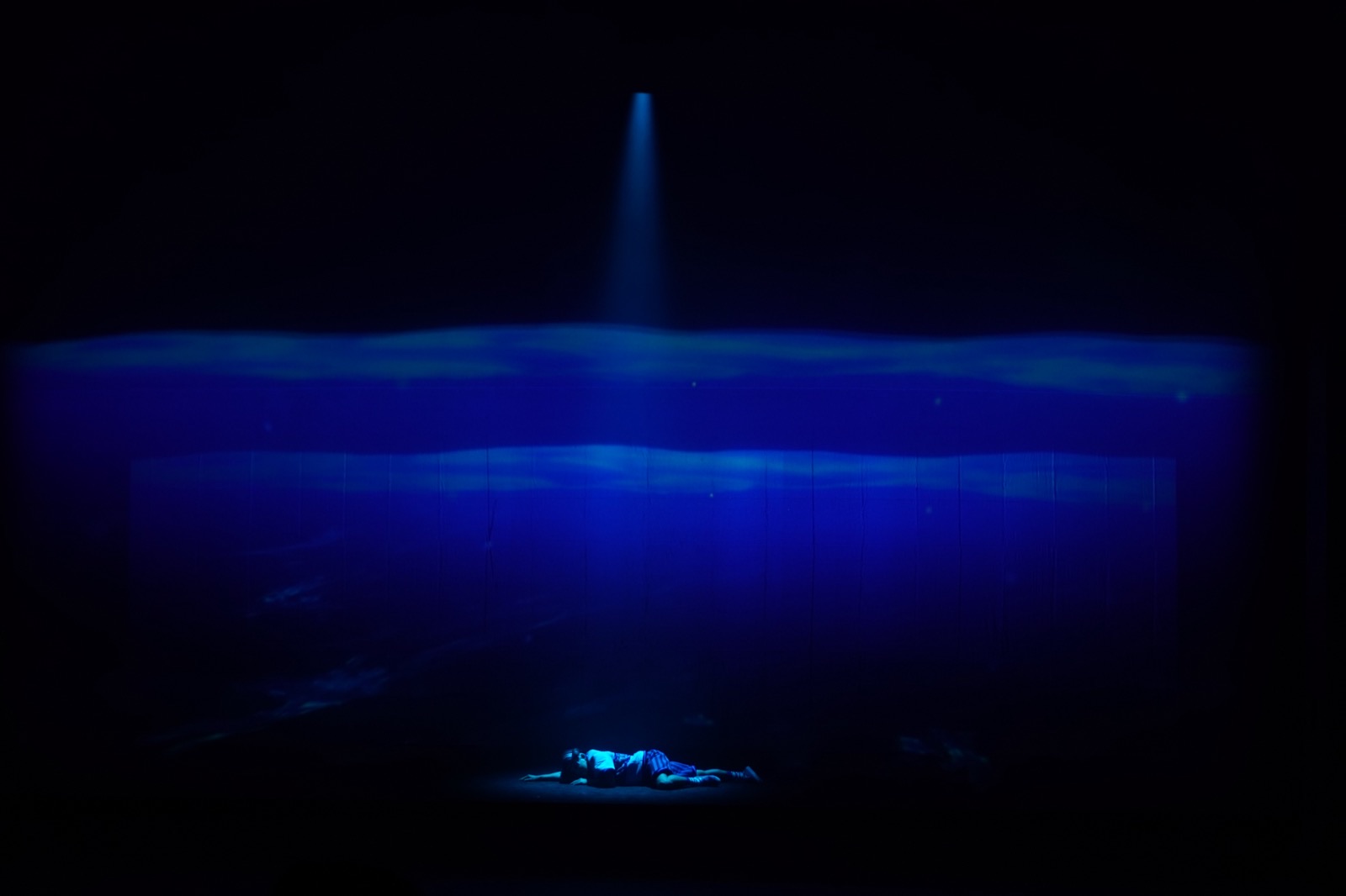 Deep ocean solo with single spotlight