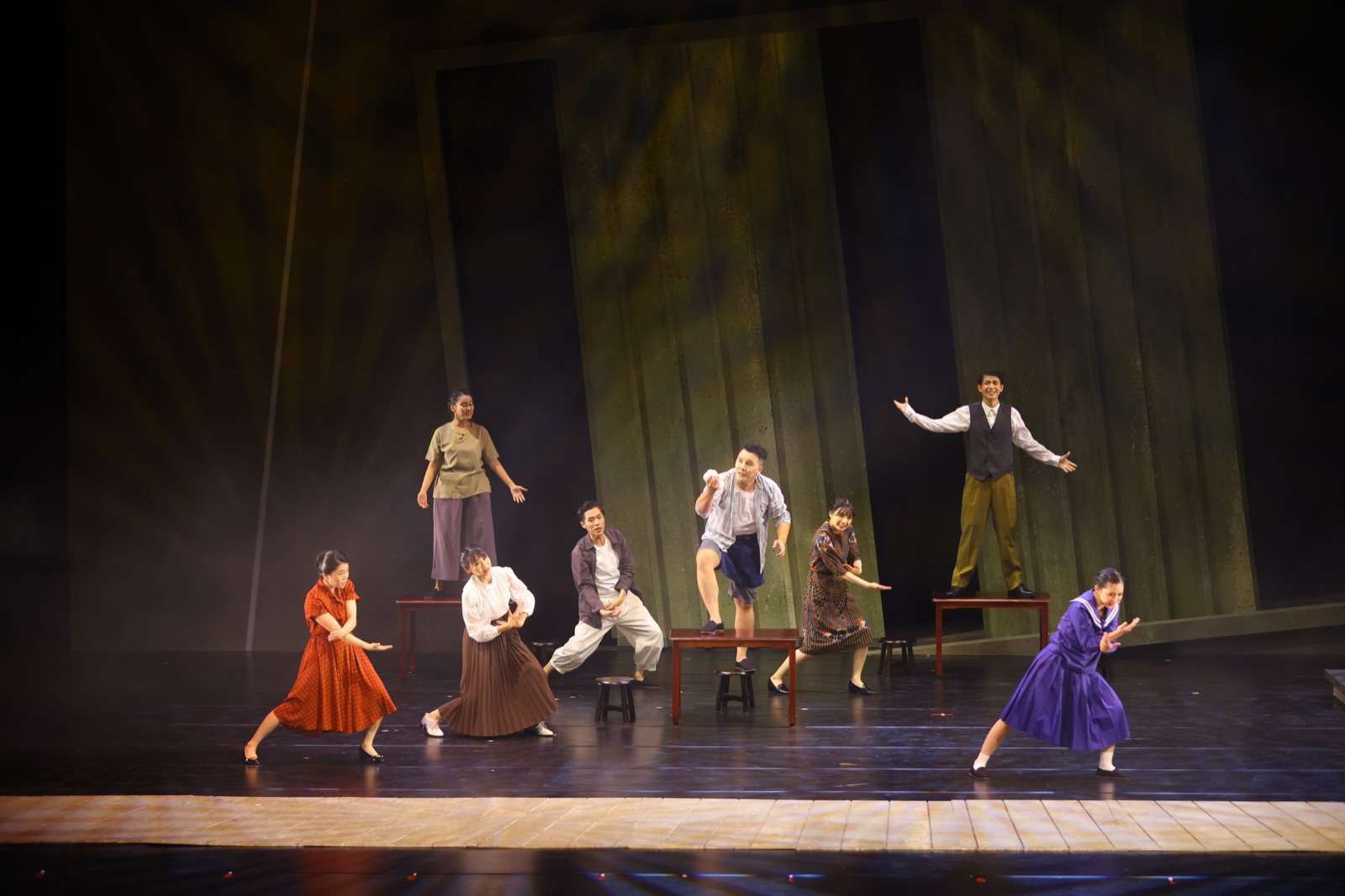 Period costume ensemble dance in green warm light