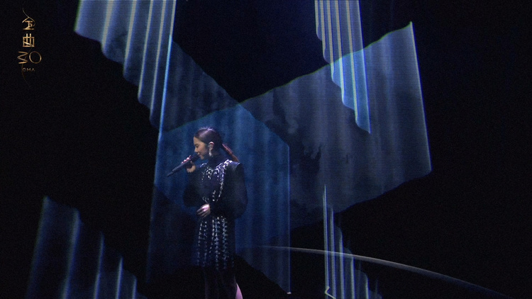 G.E.M. performing with laser beams