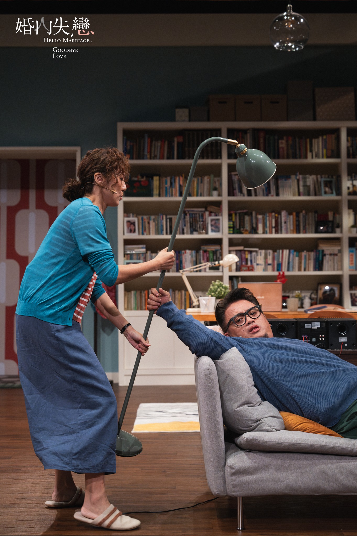 Wife confronting husband on sofa with floor lamp