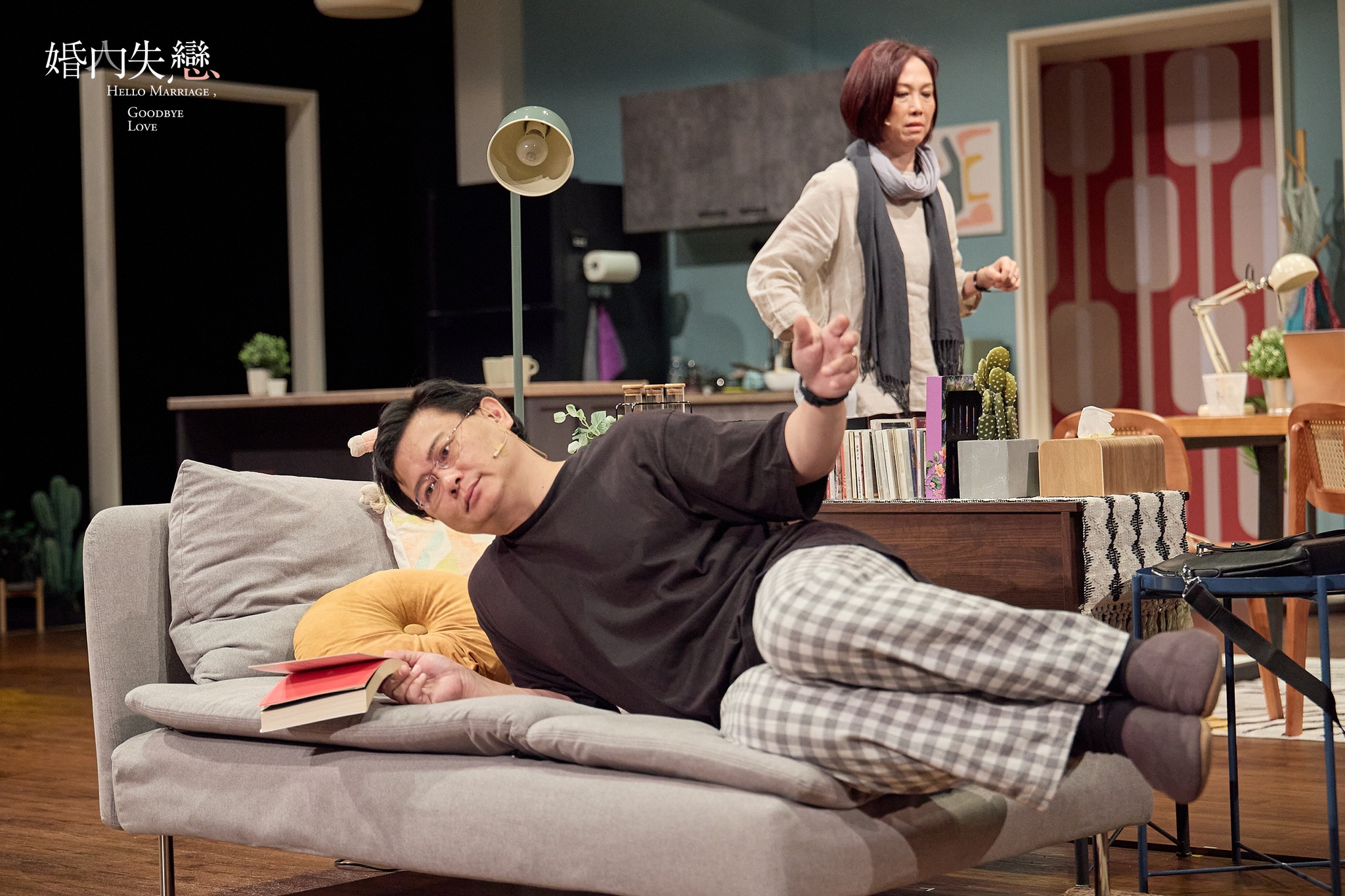 Husband on sofa with wife standing behind