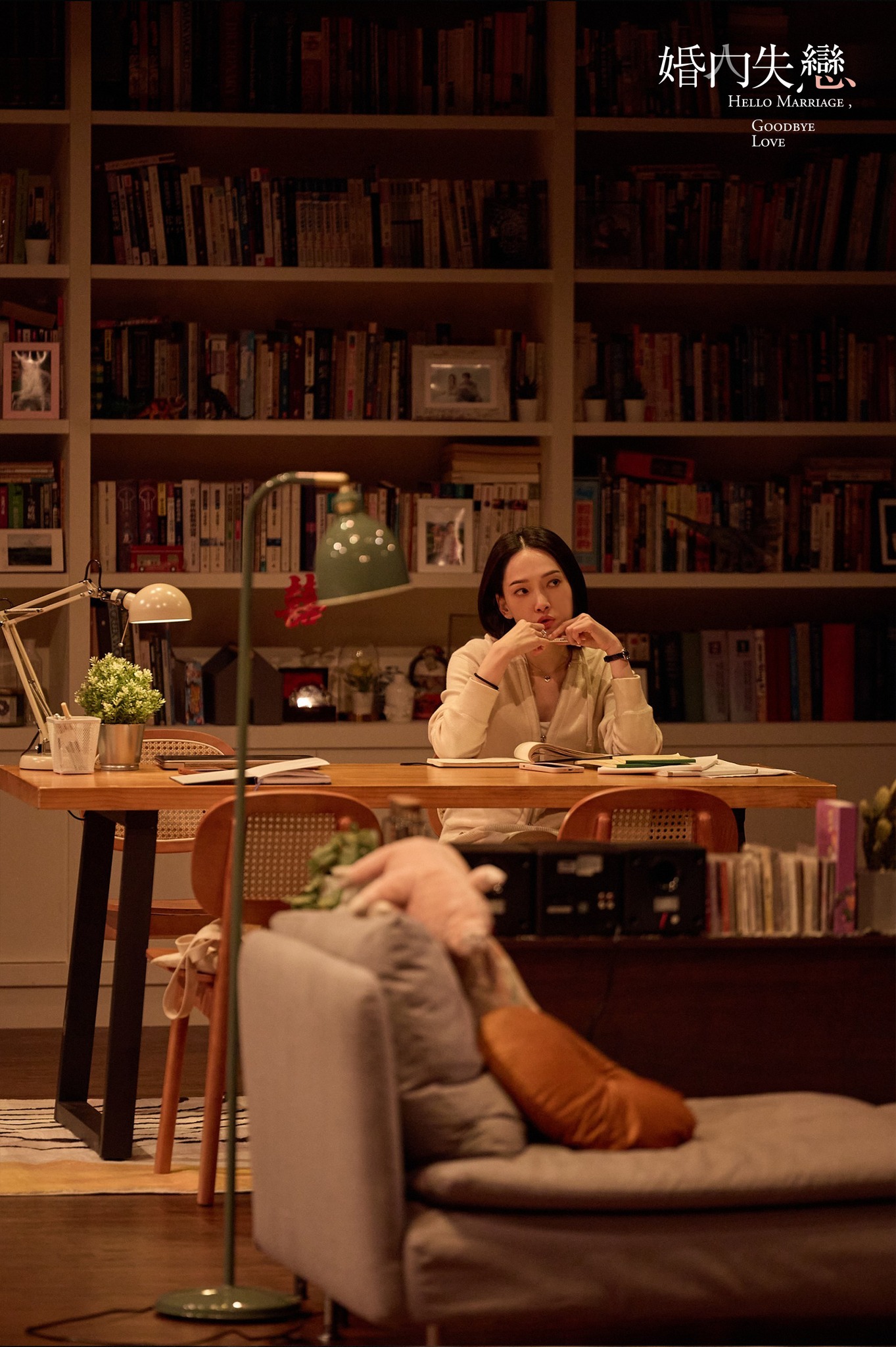 Woman alone at desk with warm reading light