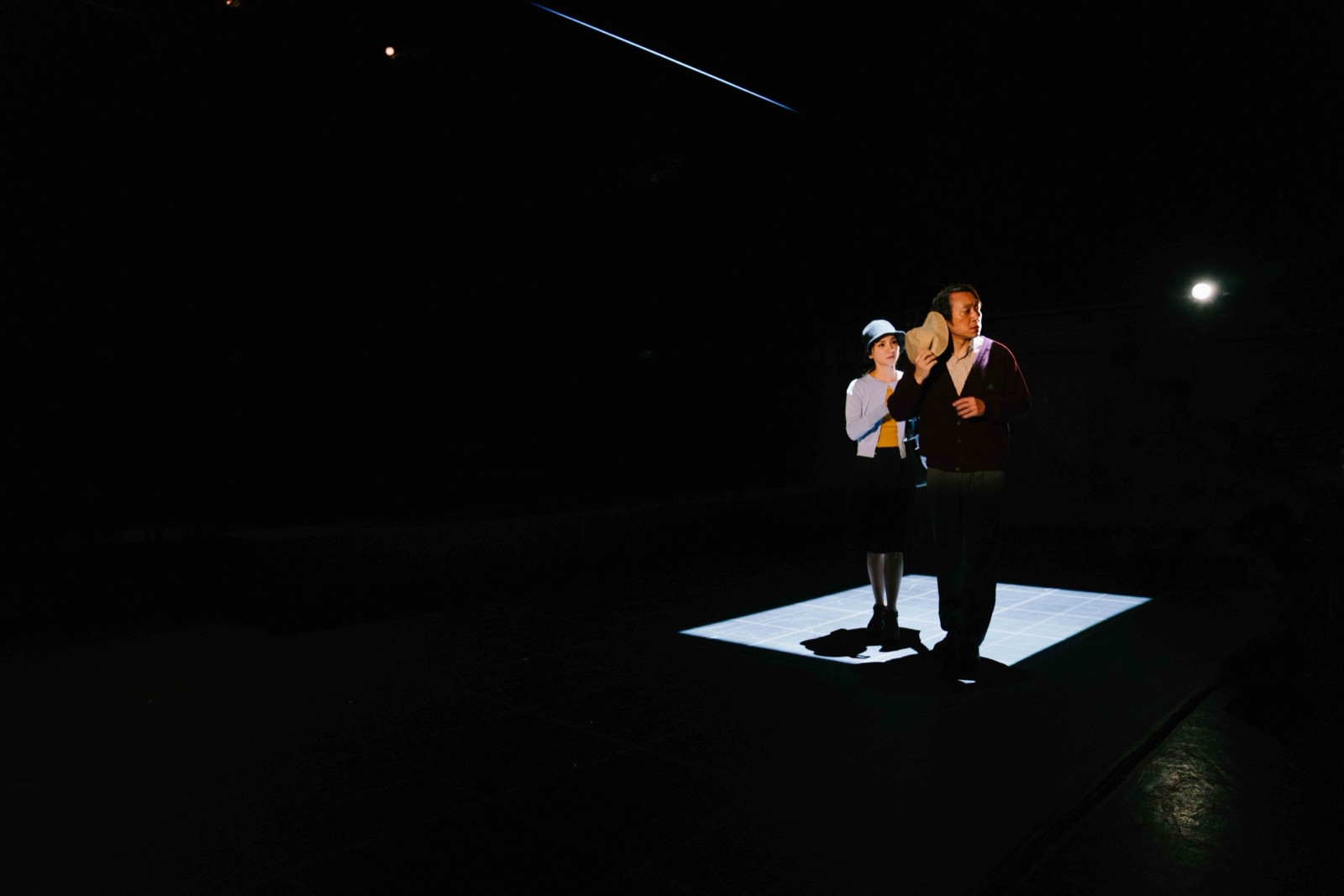 Couple standing in rectangular floor light