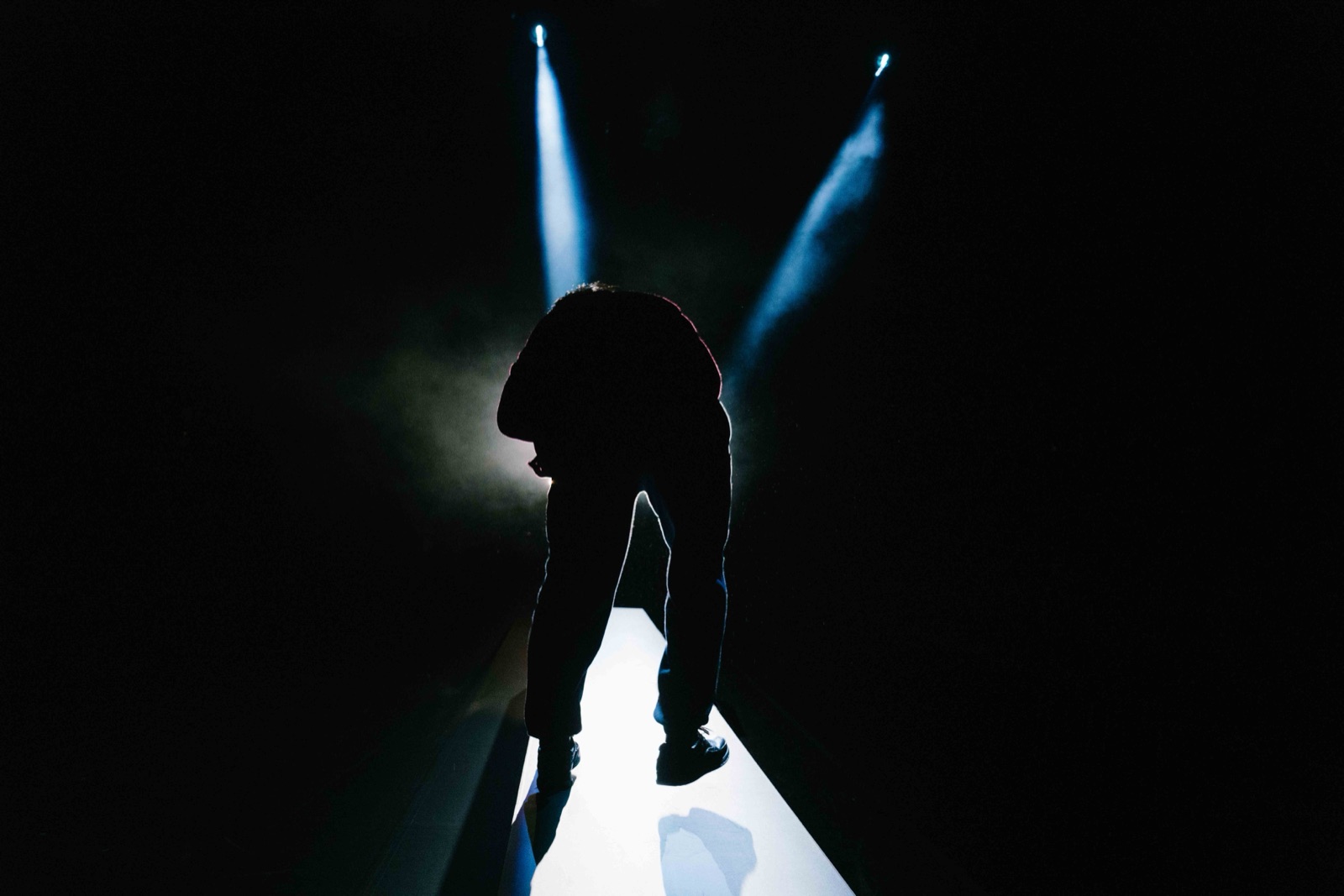 Silhouette on platform with blue backlight