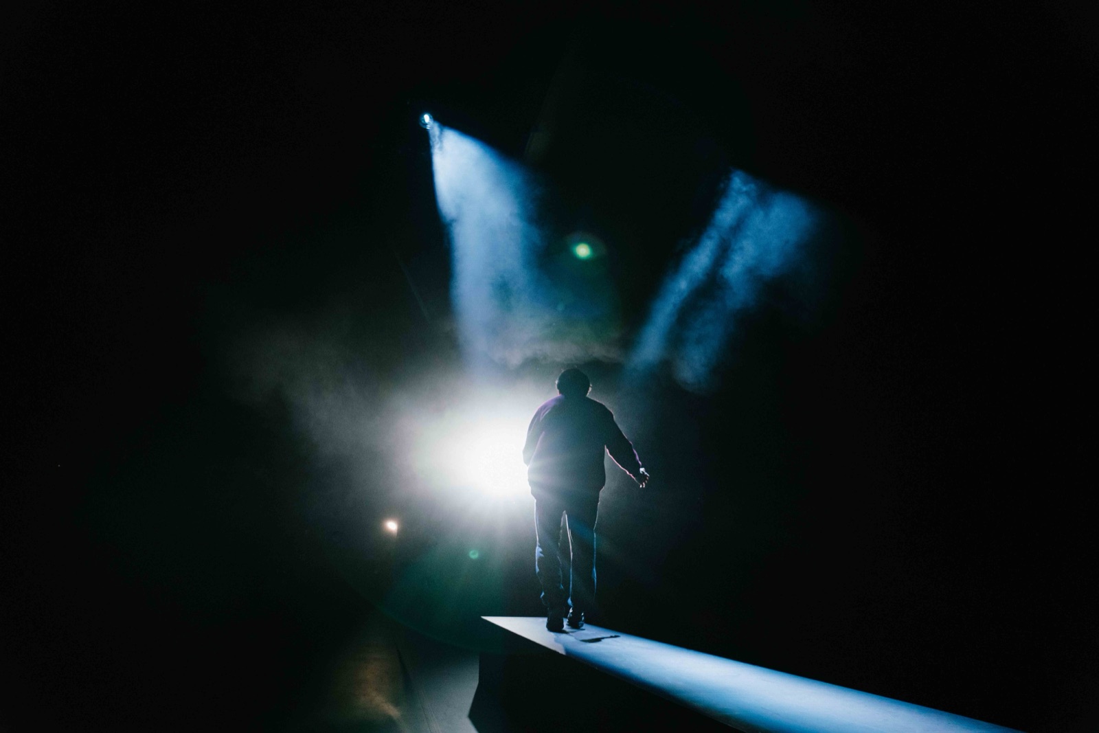 Silhouette walking through haze