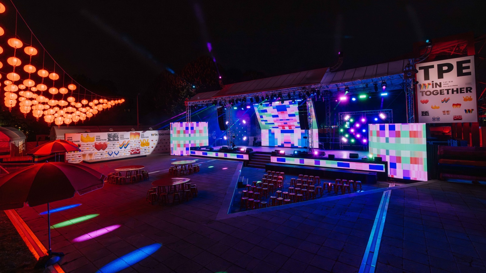 Taiwan Pavilion at night — red lanterns, beams, LED matrix walls, and colored ground wash